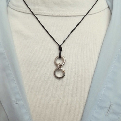 Men's black pendant with silver circles