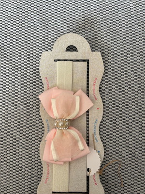 Children's pink ribbon with bow and tag