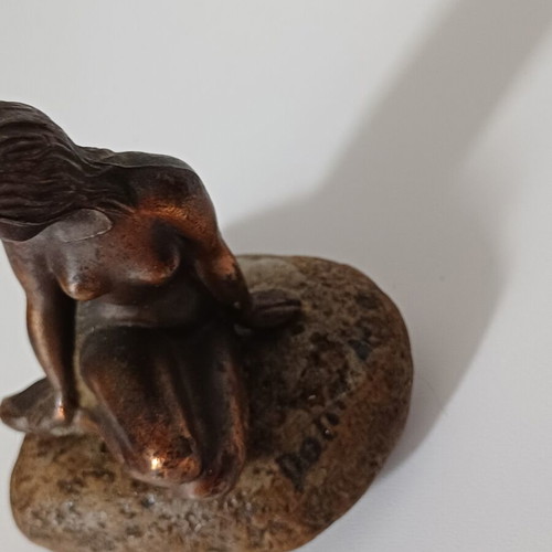 Vintage bronze Little Mermaid statue on natural stone used