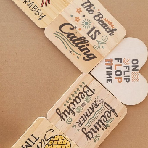 Wooden summer coasters with seasonal designs