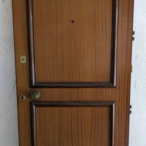 Wooden door used with double lock and peephole
