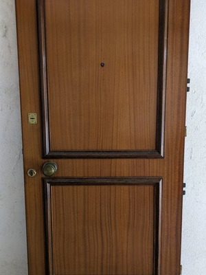 Wooden door used with double lock and peephole