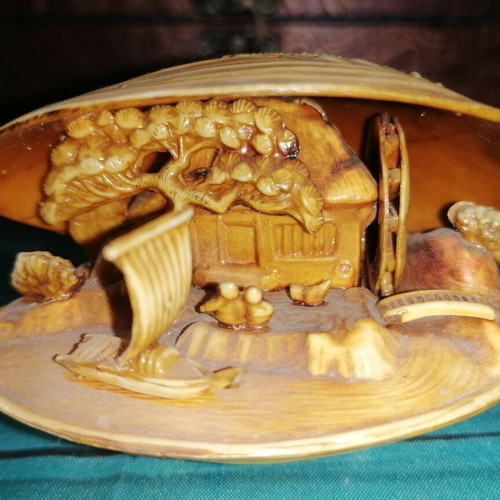 Vintage carved shell with dragon and scenic details
