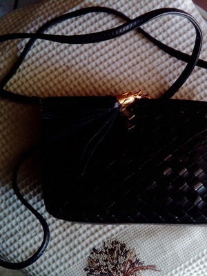 Black crossbody shoulder bag with woven intrecciato pattern