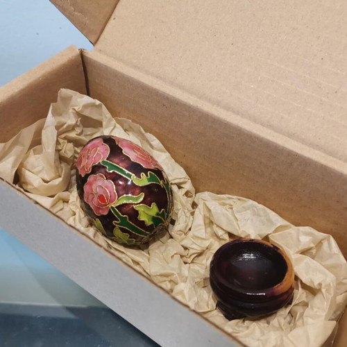 Cloisonne egg used with pink flowers and wooden base