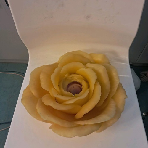 Large decorative rose candle used, yellow