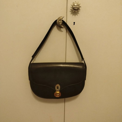Black leather vintage handbag used with white residue