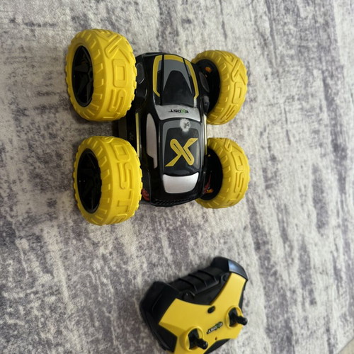 Exost 360 Cross remote control car used with yellow off-road wheels