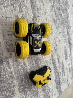 Exost 360 Cross remote control car used with yellow off-road wheels
