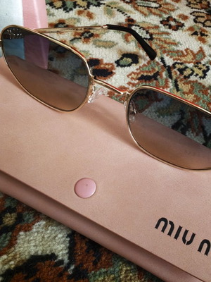 Miu Miu elegant sunglasses, gold oval frame
