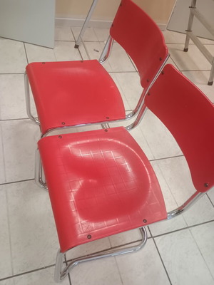 Red used chairs and single desks, 60x45 cm