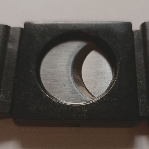 Black plastic cigar cutter used with metal cutting edges