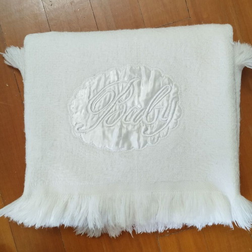 Baby white blanket used with satin decorative applique and fringes