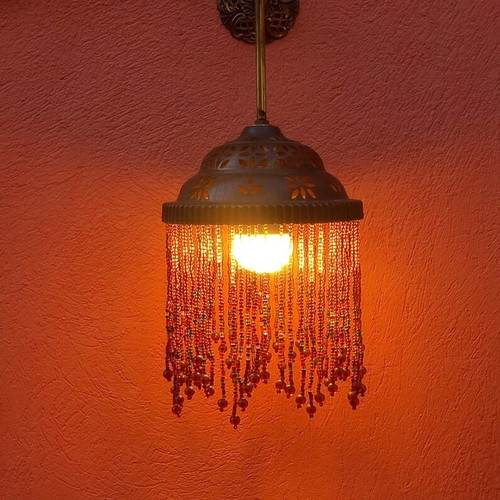 Wall light with beaded fringe