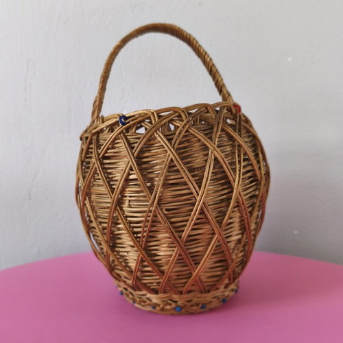 Handmade woven basket used with handle and decorative beads