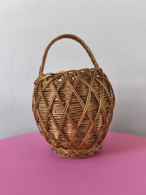 Handmade woven basket used with handle and decorative beads