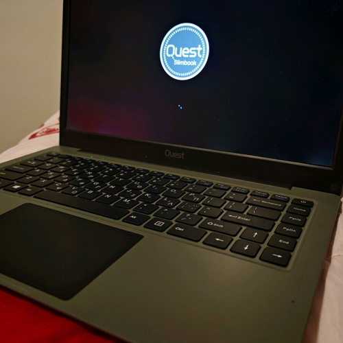 Quest Slimbook Plus 14.1" FHD laptop used with mouse and bag