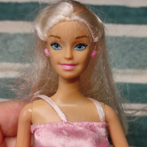 Barbie doll used with dress tears