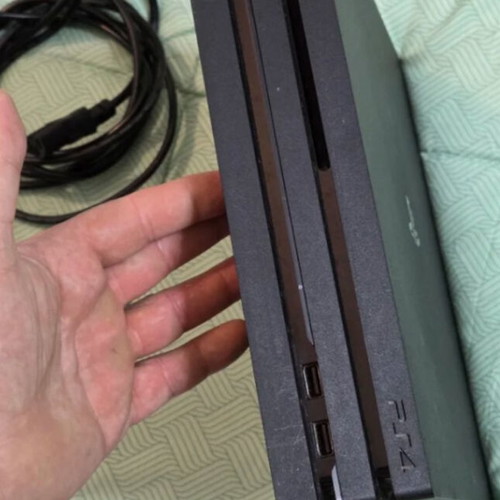 PS4 Pro 1TB console used with two controllers