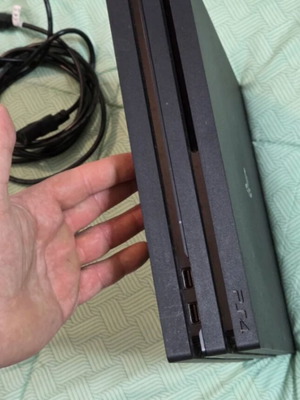PS4 Pro 1TB console used with two controllers