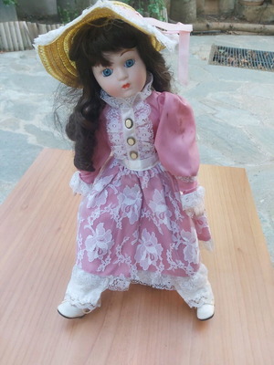 Porcelain doll new with stand for support