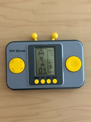 Vintage XM Game handheld console with multiple games