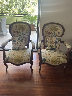 Pair of vintage armchairs with wooden frame and floral upholstery used