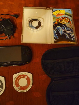 Sony PSP Street E1004 console with charger, case and 3 game cartridges