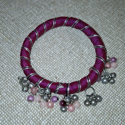 Fabric bracelet used, purple with bells
