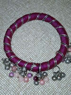 Fabric bracelet used, purple with bells