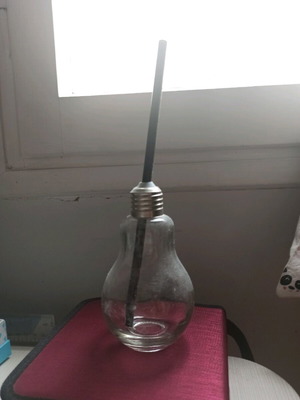 Glass cup shaped like a light bulb used with straw