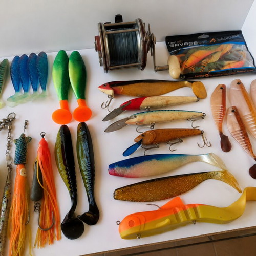 Penn Senator 114H fishing reel with large set of unused artificial lures and soft baits
