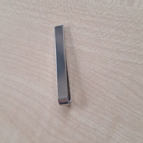 Silver tie clip used, gray