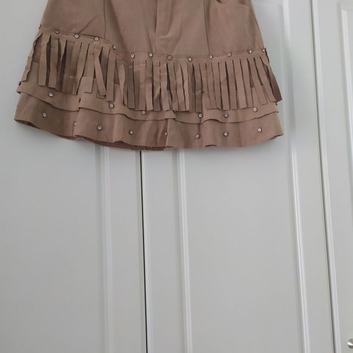 Skirt used with suede-type fringes and matte antique gold details