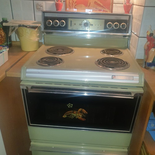 Vintage 1970s home appliance set used, General Electric fridge, Kenmore stove, Ariston washer