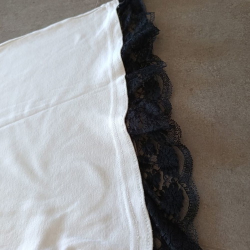 White top with black lace hem, X-back cut
