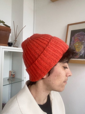 Knitted hat like new in bright orange