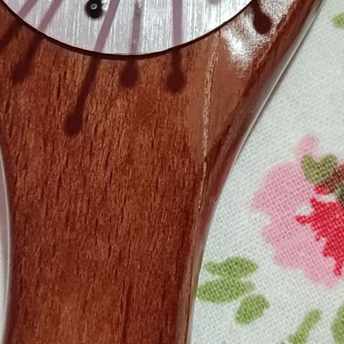 Small hairbrush with metal pins and rubber cushion