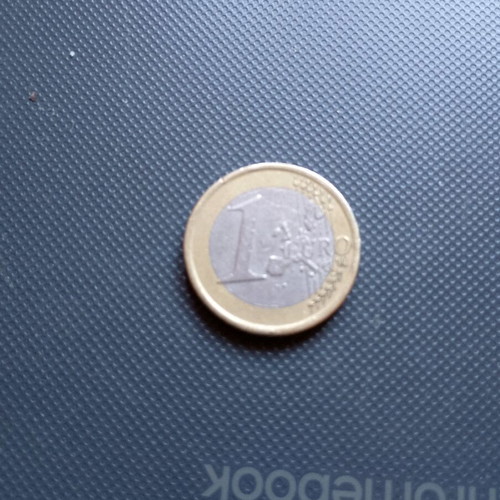 One euro coin used, unrecognizable