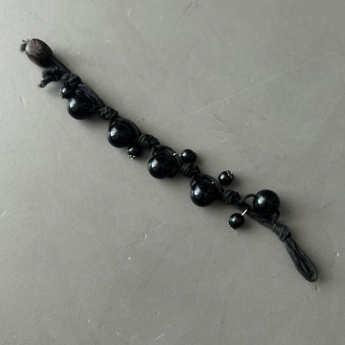 Black bracelet with beads and silver details like new, adjustable knot