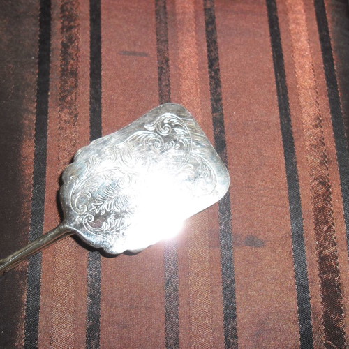 Silver serving spatula used, ornate