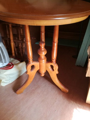Wooden round coffee table used with carved base