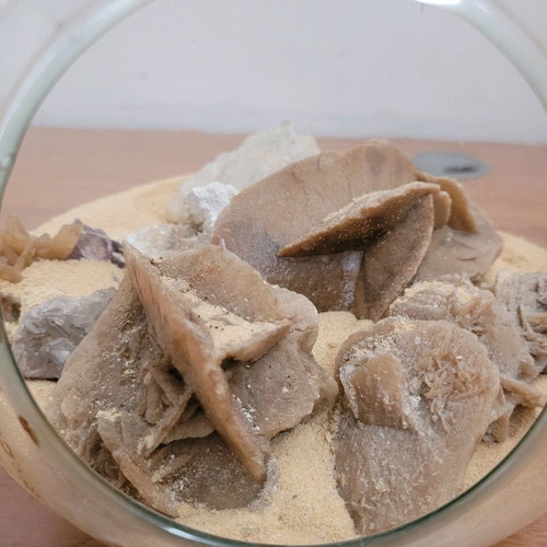 Desert rose used with agate and amethyst in glass bowl