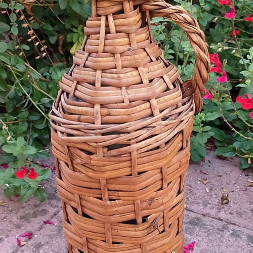 Vintage wicker wrapped demijohn with corncob stopper, used