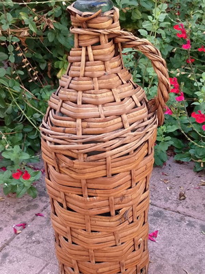 Vintage wicker wrapped demijohn with corncob stopper, used
