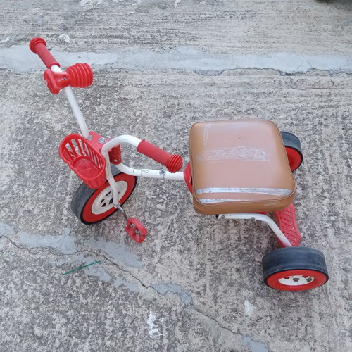 Red children's tricycle with extra foam seat