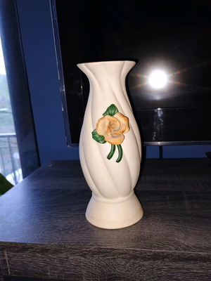 White ceramic vase with embossed orange rose used