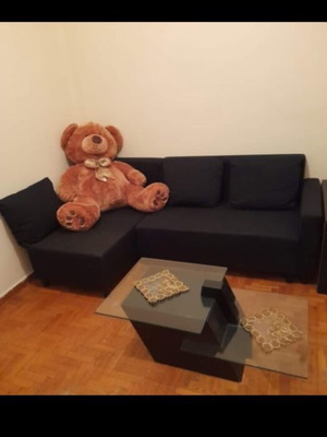 Lugnvik IKEA corner sofa bed used with storage and coffee table