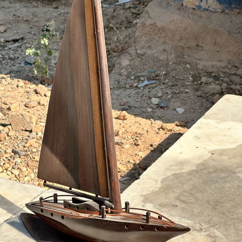Handmade wooden sailboat used on base, modern nautical decoration