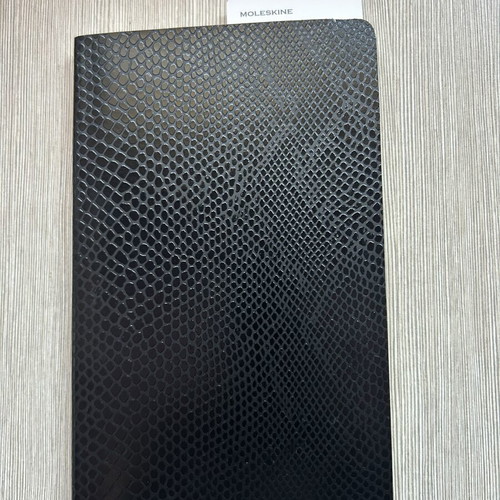 Moleskine black notebook with embossed cover